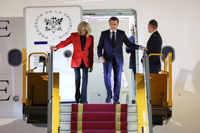 France's President Emmanuel Macron and his wife Brigitte Macron leave the plane at Noi Bai International Airport in Vietnam, shortly after the incident captured on video.