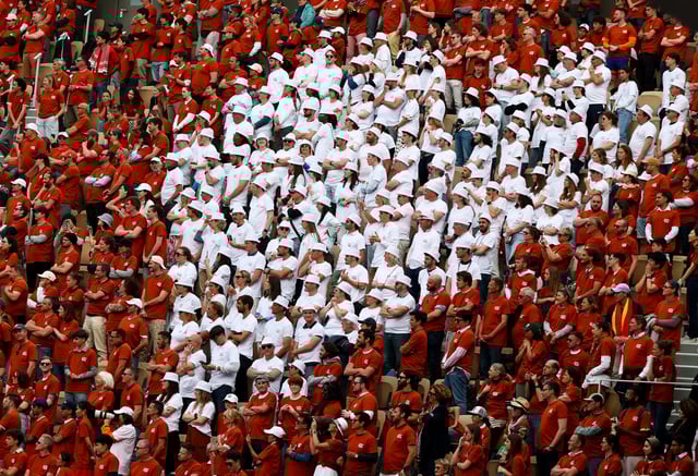 Tennis - French Open - Roland Garros, Paris, France - May 25, 2025 Spectators in the stands make a heart with special "Merci Rafa' tees provided for a tribute to former tennis player and record French Open winner Rafael Nadal REUTERS/Gonzalo Fuentes