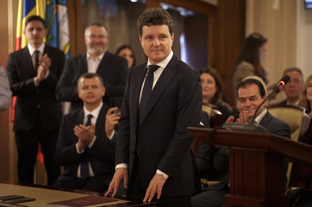 Romanian President elect Nicusor Dan, front center, stands at the Constitutional Court during the ceremony for validation of his presidential mandate, after winning the country's presidential election redo in Bucharest, Romania, Thursday, May 22, 2025. (AP Photo/Vadim Ghirda)