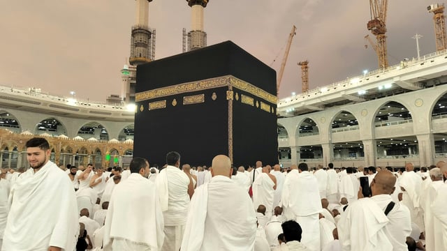 Muslims in white robes pray around the Kaaba, Islam's holiest shrine, at the Grand Mosque in Saudi Arabia's holy city of Mecca. Know the date and all about the annual hajj pilgrimage here.