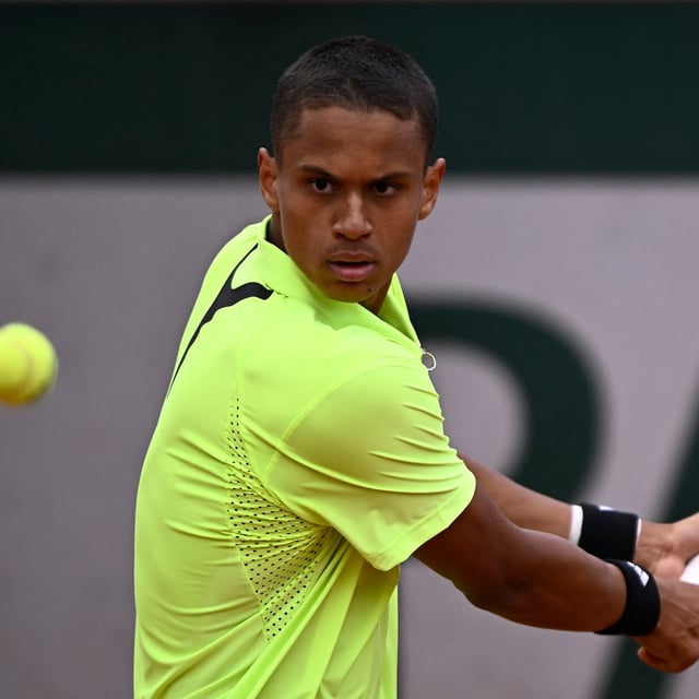 Canada's Gabriel Diallo plays a backhand return to Argentina's Francisco Cerundolo during their men's singles match on day 2 of the French Open tennis tournament at the Roland-Garros Complex in Paris on May 26, 2025. (Photo by JULIEN DE ROSA / AFP) (Photo by JULIEN DE ROSA/AFP via Getty Images)