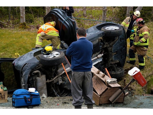  Two people were trapped in their SUV after it rolled over in St. Philip’s Monday afternoon.