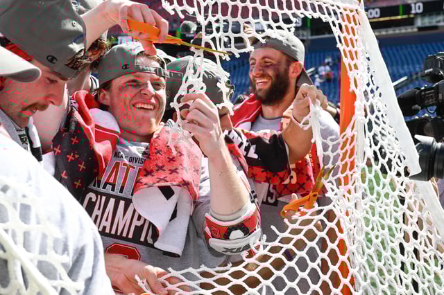 May 26, 2025; Foxborough, MA, USA; Members of the Cornell Big Red cut pieces of their net after winning the NCAA Division I Mens Lacrosse Championship at Gillette Stadium. Mandatory Credit: Eric Canha-Imagn Images