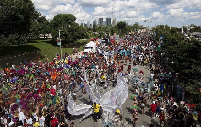 Paraders march down Lakeshore Boulevard at the Caribbean Carnival in Toronto on Saturday, August 3, 2013. 