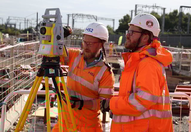 Workers operate a piece of measuring equipment at the HS2 rail Curzon Street Station construction site in Birmingham, Britain, October 3, 2022. REUTERS/Phil Noble/File Photo