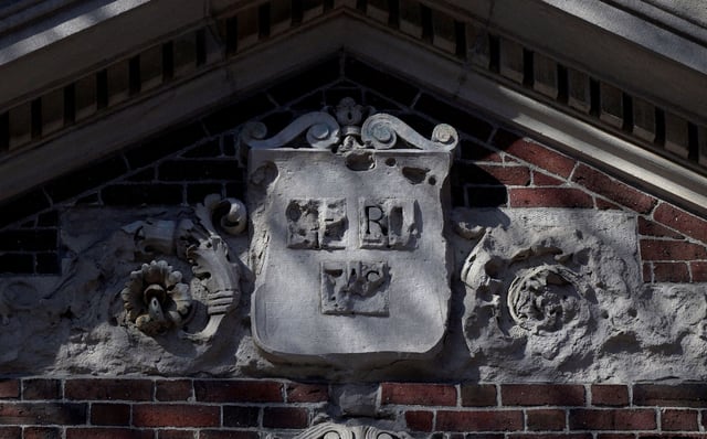 The Harvard University shield "VERITAS" sits above a campus entrance gate at Harvard University in Cambridge, Massachusetts, U.S., April 15, 2025.