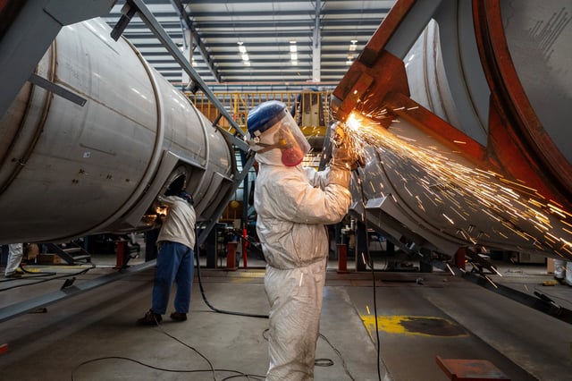 Workers work on a production line, manufacturing tank containers at a factory in Nantong, Jiangsu province, China April 7, 2025. cnsphoto via REUTERS/ File Photo