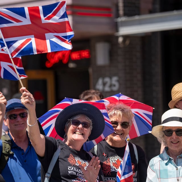 Royal fans wave as they wait for the arrival of King Charles and Queen Camilla at Lansdowne Park in Ottawa.