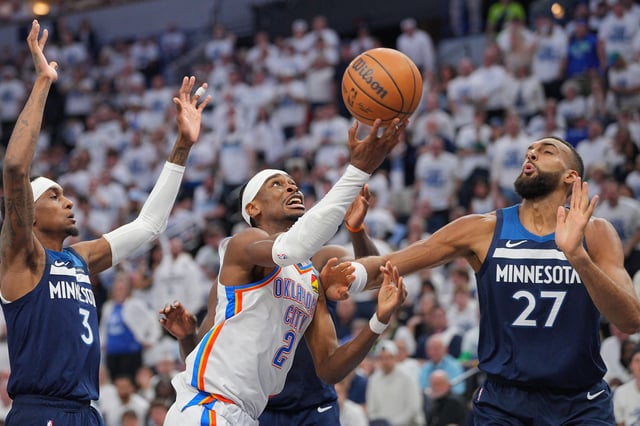 May 24, 2025; Minneapolis, Minnesota, USA; Oklahoma City Thunder guard Shai Gilgeous-Alexander (2) shoots the ball over Minnesota Timberwolves center Rudy Gobert (27) during the first half in game three of the western conference finals for the 2025 NBA Playoffs at Target Center. Mandatory Credit: Brad Rempel-Imagn Images