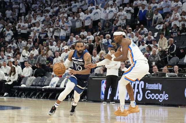 May 26, 2025; Minneapolis, Minnesota, USA; Minnesota Timberwolves guard Mike Conley (10) dribbles the ball past Oklahoma City Thunder guard Shai Gilgeous-Alexander (2) in the second half during game four of the western conference finals for the 2025 NBA Playoffs at Target Center. Mandatory Credit: Bruce Kluckhohn-Imagn Images