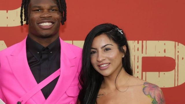 Travis Hunter and Leanna Lenee on the red carpet before the 2025 NFL Draft at Lambeau Field.