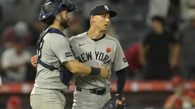 May 26, 2025; Anaheim, California, USA;  New York Yankees relief pitcher Luke Weaver (30) is congratulated by catcher Austin Wells (28) after the final out of the ninth inning against the Los Angeles Angels at Angel Stadium. Mandatory Credit: Jayne Kamin-Oncea-Imagn Images
