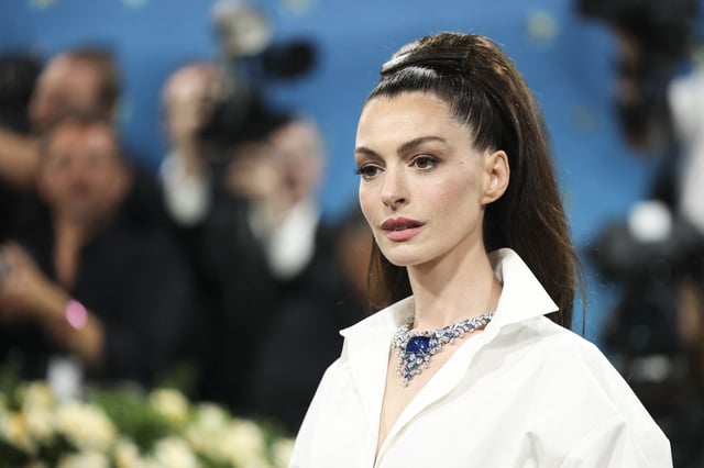 Anne Hathaway poses during the Met Gala, an annual fundraising gala held for the benefit of the Metropolitan Museum of Art's Costume Institute with this year's theme 'Superfine: Tailoring Black Style,' in New York City, New York, U.S., May 5, 2025. REUTERS/Mario Anzuoni/File Photo