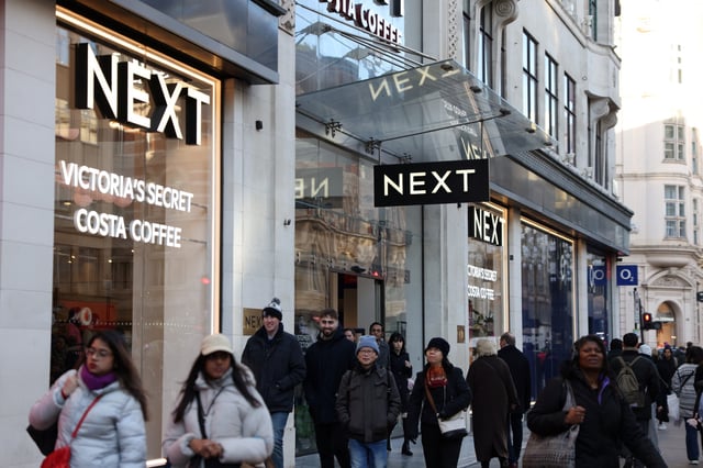 Shoppers walk past a NEXT retail store in London, Britain, January 2, 2025. REUTERS/Hollie Adams/File Photo