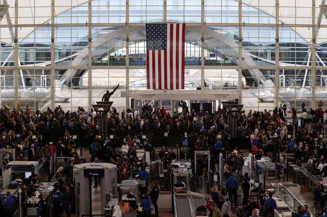 File photo: travelers make their way through a TSA security checkpoint at Denver International Airport.