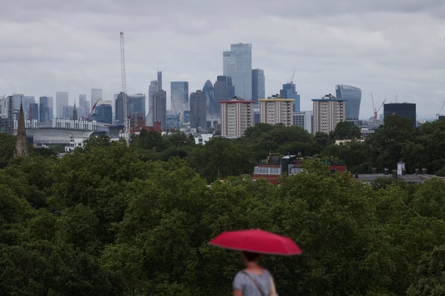 A woman walks past a view the London's skyline from Primrose Hill in London, Britain, July 25, 2024. REUTERS/Hollie Adams/File Photo
