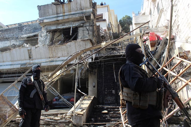 Members of Syrian security forces stand guard at a damaged site, after Israel carried out an air strike on the Syrian capital Damascus on Thursday, as reported by Syria's state news agency, in Damascus, Syria March 13, 2025. REUTERS/Firas Makdesi/File Photo
