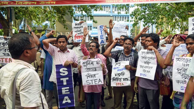 Teachers and non-teaching staff stage a sit-in protest against police lathi-charge on protesters on May 15 in front of Bikash Bhawan in Kolkata 