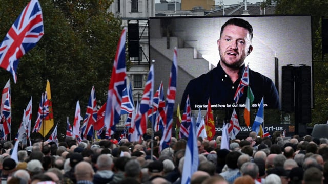 Tommy Robinson, anti-immigration activist, is displayed on a screen, as people attend an anti-immigration protest, in London, Britain, October 26, 2024. REUTERS/Chris J Ratcliffe/File Photo