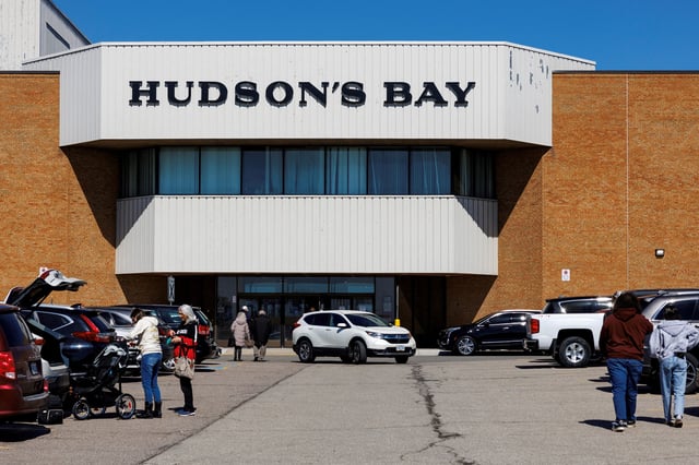 People walk into a Hudson's Bay store in Hamilton, Ontario, Canada March 21, 2025.  REUTERS/Carlos Osorio/File Photo