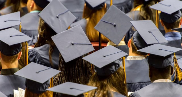 A group of graduating student wearing caps.