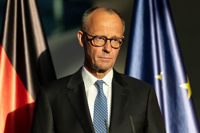 BERLIN, GERMANY - MAY 06: New Chancellor Friedrich Merz of the German Christian Democrats (CDU) speaks next to outgoing German Chancellor Olaf Scholz (not seen) during a handover ceremony at the Chancellery following Merz’s election at a special session of the Bundestag on May 6, 2025 in Berlin, Germany. The new government is a coalition of Christian Democrats (CDU/CSU) and Social Democrats (SPD). (Photo by Maja Hitij/Getty Images)