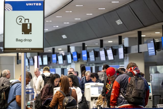 Travelers use kiosks at the United Airlines check-in area at San Francisco International Airport (SFO) in San Francisco, California, US, on Friday, May 23, 2025. Flyers heading out for the Memorial Day holiday in the US are bracing for stress as record numbers of travelers place fresh strain on an outmoded and undermanned air traffic system. Photographer: David Paul Morris/Bloomberg via Getty Images

