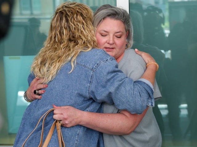  Kyla Herman, left and Whitney Mercer hug after talking to media at the Calgary Courts Centre on Tuesday May 27, 2025. The mothers had children in daycare who were infected with E. coli during an outbreak linked to a kitchen operated by Fueling Minds Inc. The company pleaded guilty in April to four offences relating to the company’s failure to have a catering licence and was fined $10,000.Gavin Young/Postmedia