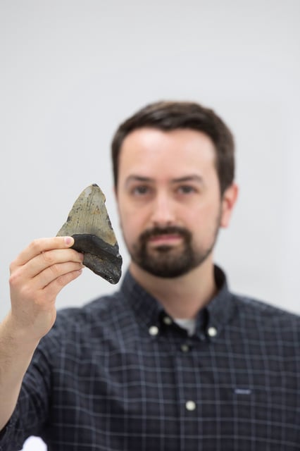 Jeremy McCormack with a fossilized megalodon tooth (Otodus megalodon).