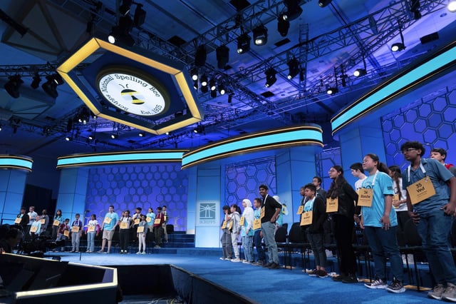 Participants stand up as they compete during the first preliminary round of the Scripps National Spelling Bee at the Gaylord National Resort & Convention Center, Tuesday, May 27, 2025, in Oxon Hill, Md. (AP Photo/Jose Luis Magana)