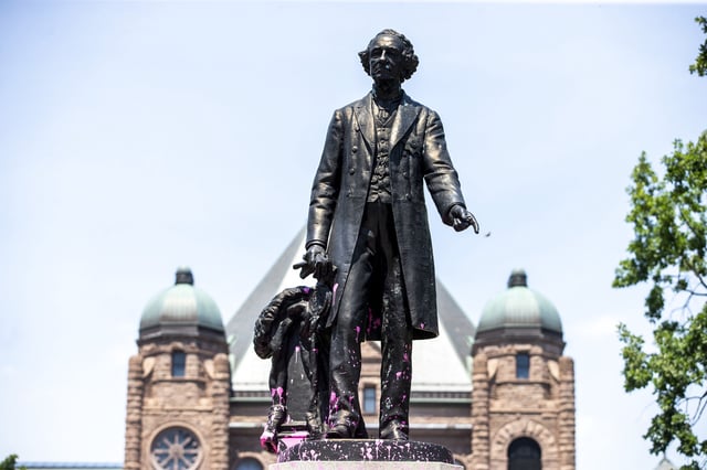 Demonstrators threw pink paint on a statue of Sir. John A. Macdonald at QueenÕs Park in Toronto on Saturday, July 18, 2020. 
