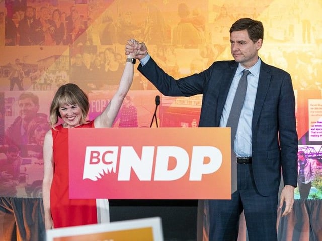 NDP leader David Eby and his wife Cailey Lynch on stage to speak to supporters at NDP party headquarters in Vancouver on election night