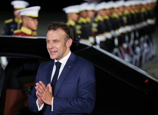 French President Emmanuel Macron gestures upon his arrival at military airbase Halim Perdanakusuma in Jakarta, Indonesia, May 27, 2025. REUTERS/Ajeng Dinar Ulfiana
