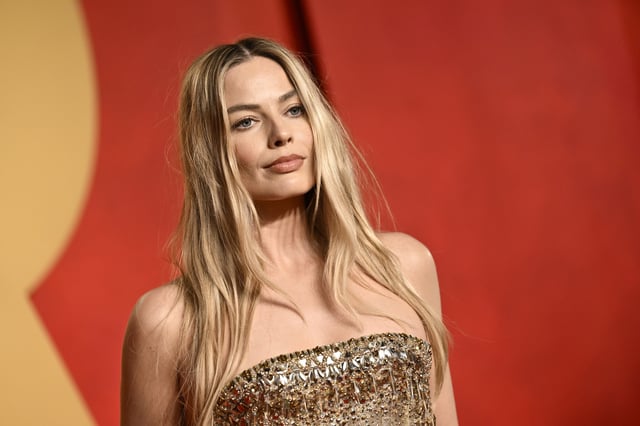 FILE: Margot Robbie arrives at the Vanity Fair Oscar Party, March 10, 2024, at the Wallis Annenberg Center for the Performing Arts in Beverly Hills, Calif. The “Barbie” producer and star is making a Monopoly movie, with Hasbro and Lionsgate behind it, the companies announced Wednesday, April 10, at the CinemaCon conference in Las Vegas.