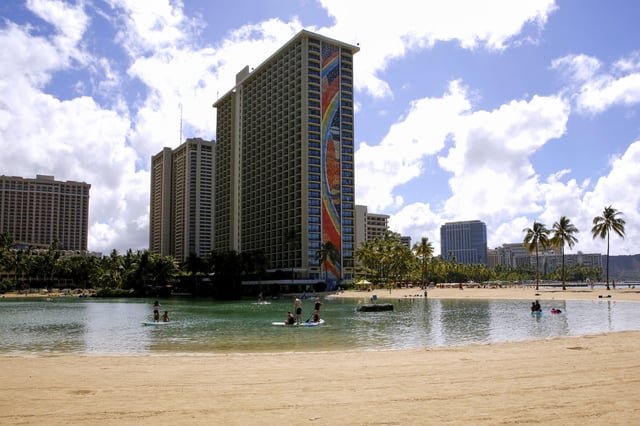 FILE - People swim in the lagoon in front of the Hilton Hawaiian Village resort in Honolulu on Saturday, Sept. 4, 2021. (AP Photo/Caleb Jones, File)
