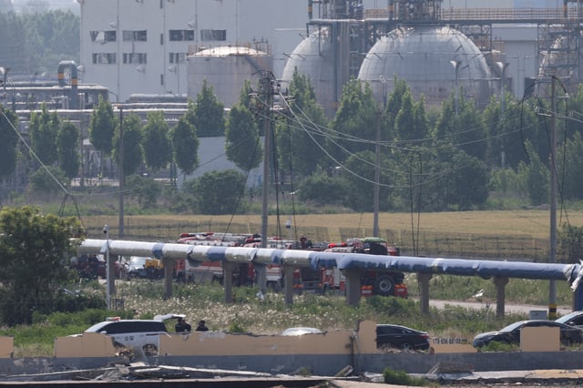 A police car and fire trucks are parked near the site of the chemical plant explosion in Gaomi, Shandong province, China May 28, 2025. REUTERS/Go Nakamura