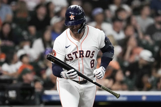 Houston Astros Christian Walker (8) looks down at his bat after popping up during the first inning of an MLB baseball game in Houston, Tuesday, May 27, 2025.