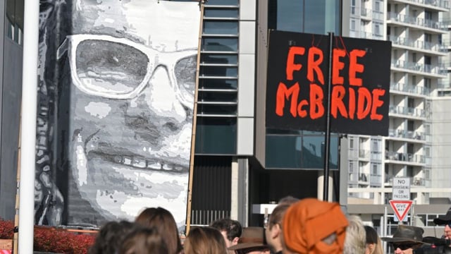 Supporters of jailed whistleblower David McBride hold banners and signs outside the ACT Supreme Court. (AAP Image/Mick Tsikas)