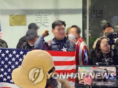 A supporter of former President Yoon Suk Yeol, dressed as the Marvel Comics character Captain America, protests in front of the National Human Rights Commission building in Seoul, in this file photo taken Feb. 15, 2025. (Yonhap)