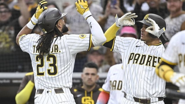 May 27, 2025; San Diego, California, USA; San Diego Padres outfielder Fernando Tatis Jr. (23) is congratulated by  Manny Machado (13) after hitting a solo home run during the first inning against the Miami Marlins at Petco Park. Mandatory Credit: Denis Poroy-Imagn Images