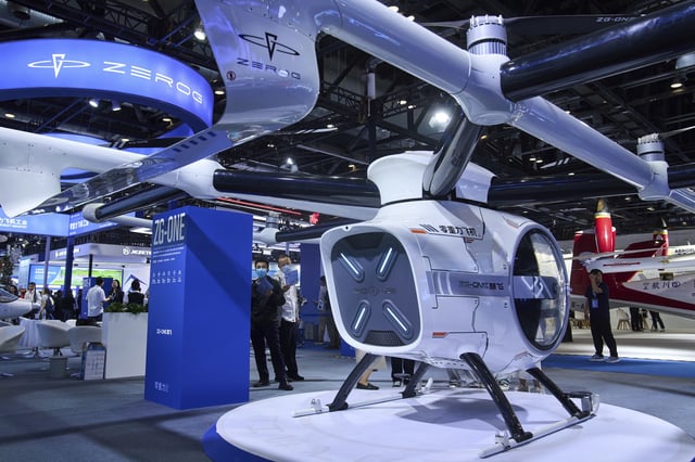 Visitors tour the ZEROG booth showcasing it ZG-ONE, a two-seated eVTOL multicopter aircraft with its autonomous piloting at the 3rd Exhibition of Technology and Education in Civil Aviation as China promoting the low-altitude economy, in Beijing, Tuesday, May 27, 2025. (AP Photo/Andy Wong)