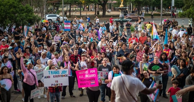 The crowd gathered at a rally for Trans Day of Visibility at the Bexar County Courthouse listens to pediatrician Dr. Lulu in San Antonio on March 31, 2023.