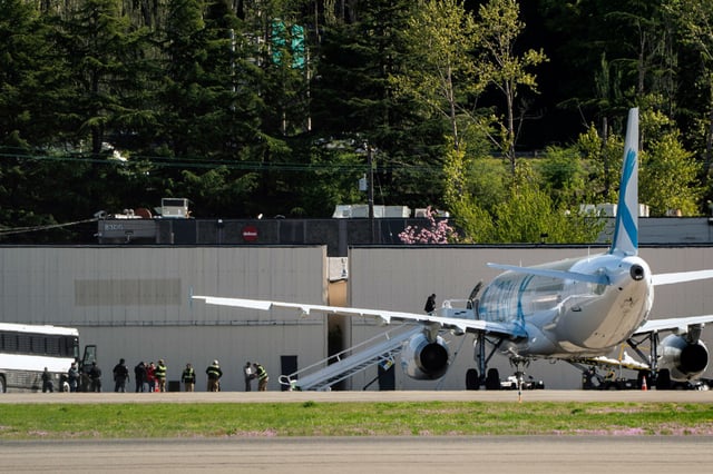 Detainees are transferred from buses to a plane chartered by U.S. Immigration and Customs Enforcement at King County International Airport on April 15, 2025 in Seattle. 