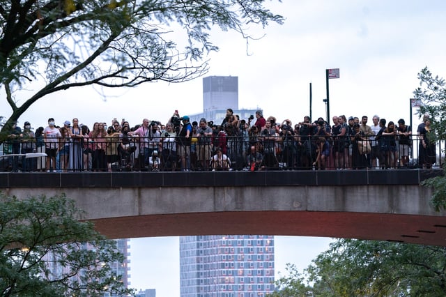Viewers gather to watch and photograph the phenomenon known as Manhattanhenge in New York City on July 11, 2021.