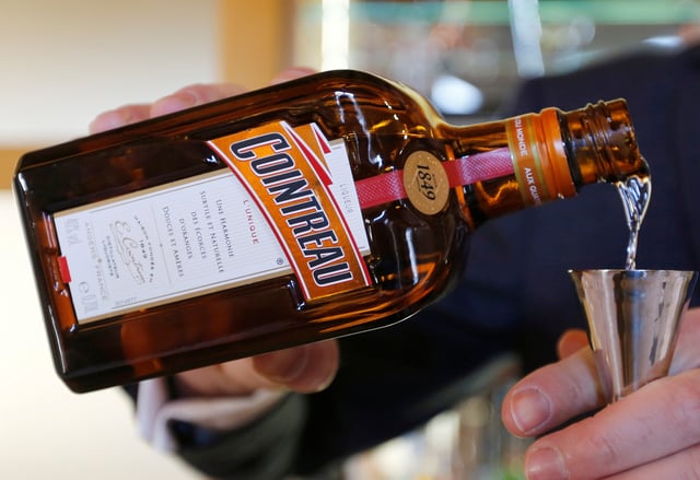A man pours Remy Cointreau into a glass at the Remy Martin factory in Cognac, France, November 21, 2018. REUTERS/Regis Duvignau/File Photo