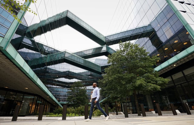 A man walks through a plaza at  the new Fannie Mae headquarters in Washington, U.S., October 4, 2022. REUTERS/Kevin Lamarque/File Photo