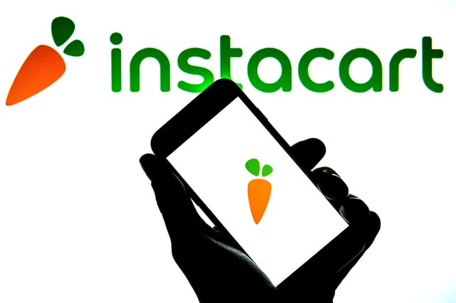 SPAIN - 2021/12/14: In this photo illustration, the Instacart logo seen displayed on a smartphone and on the background. (Photo Illustration by Thiago Prudencio/SOPA Images/LightRocket via Getty Images)