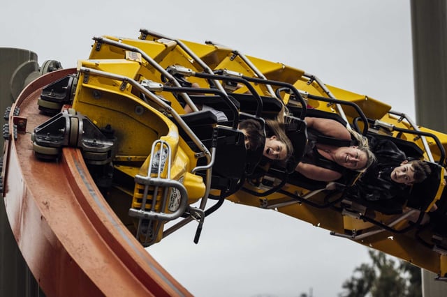 Parkgoers ride on RailBlazer, a single rail roller coaster at California&#39;s Great America in Santa Clara, Saturday, Sept. 2, 2023. Six Flags will lay off employees at Discovery Kingdom and California’s Great America as it restructures operations and eliminates local leadership roles following its $8 billion merger with Cedar Fair.