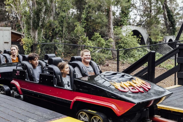 Parkgoers are seen after riding Demon, a roller coaster at California&#39;s Great America in Santa Clara, Saturday, Sept. 2, 2023. Six Flags will lay off employees at Discovery Kingdom and California’s Great America as it restructures operations and eliminates local leadership roles following its $8 billion merger with Cedar Fair.