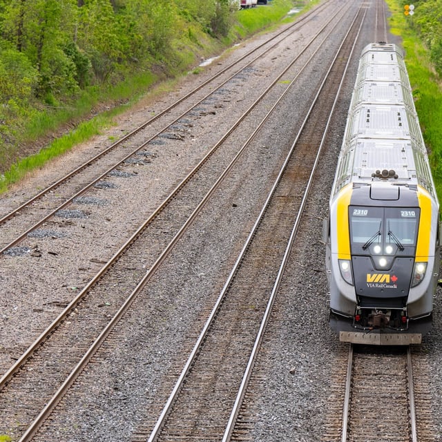 A VIA Rail train is seen on tracks in Dorval, Que., as it heads out of Montreal on Friday, May 23, 2025. THE CANADIAN PRESS/Christinne Muschi